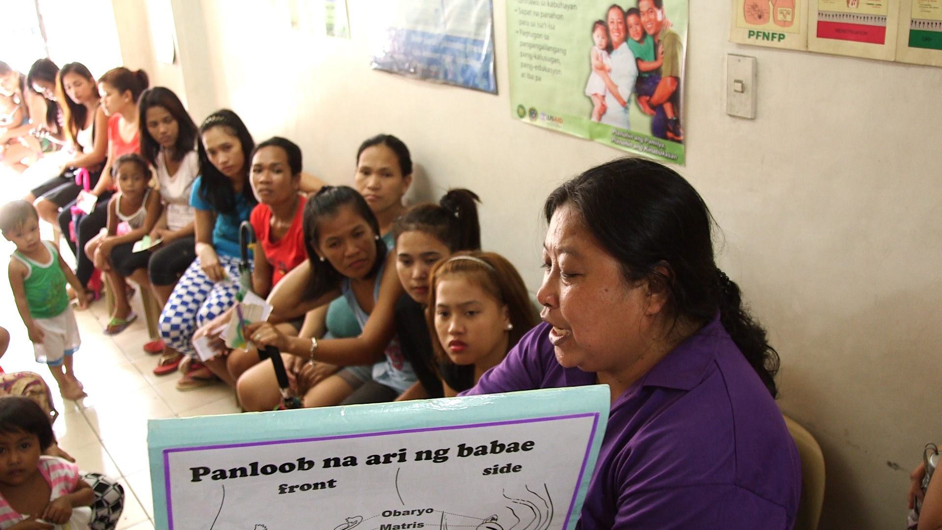 Lina Bacalando teaches a family planning workshop to a packed room of women from the nearby area. Likhaan 2